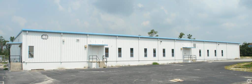Commercial building in white with blue roof