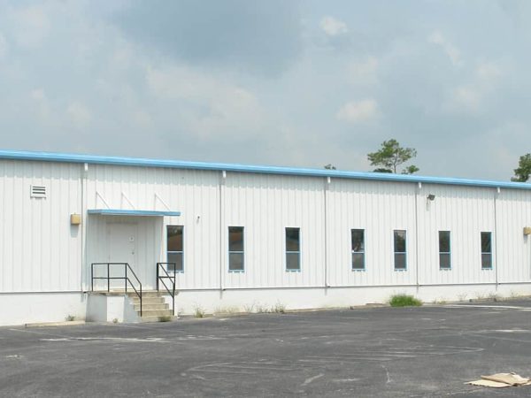 Commercial building in white with blue roof